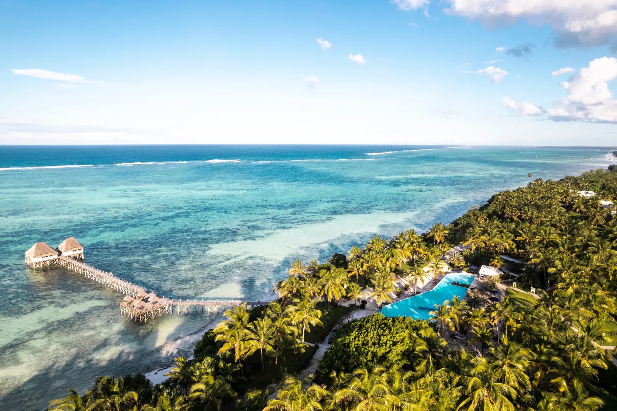 Aerial view of the overwater jetty, pool and gardens at Meliá Zanzibar, Kiwengwa