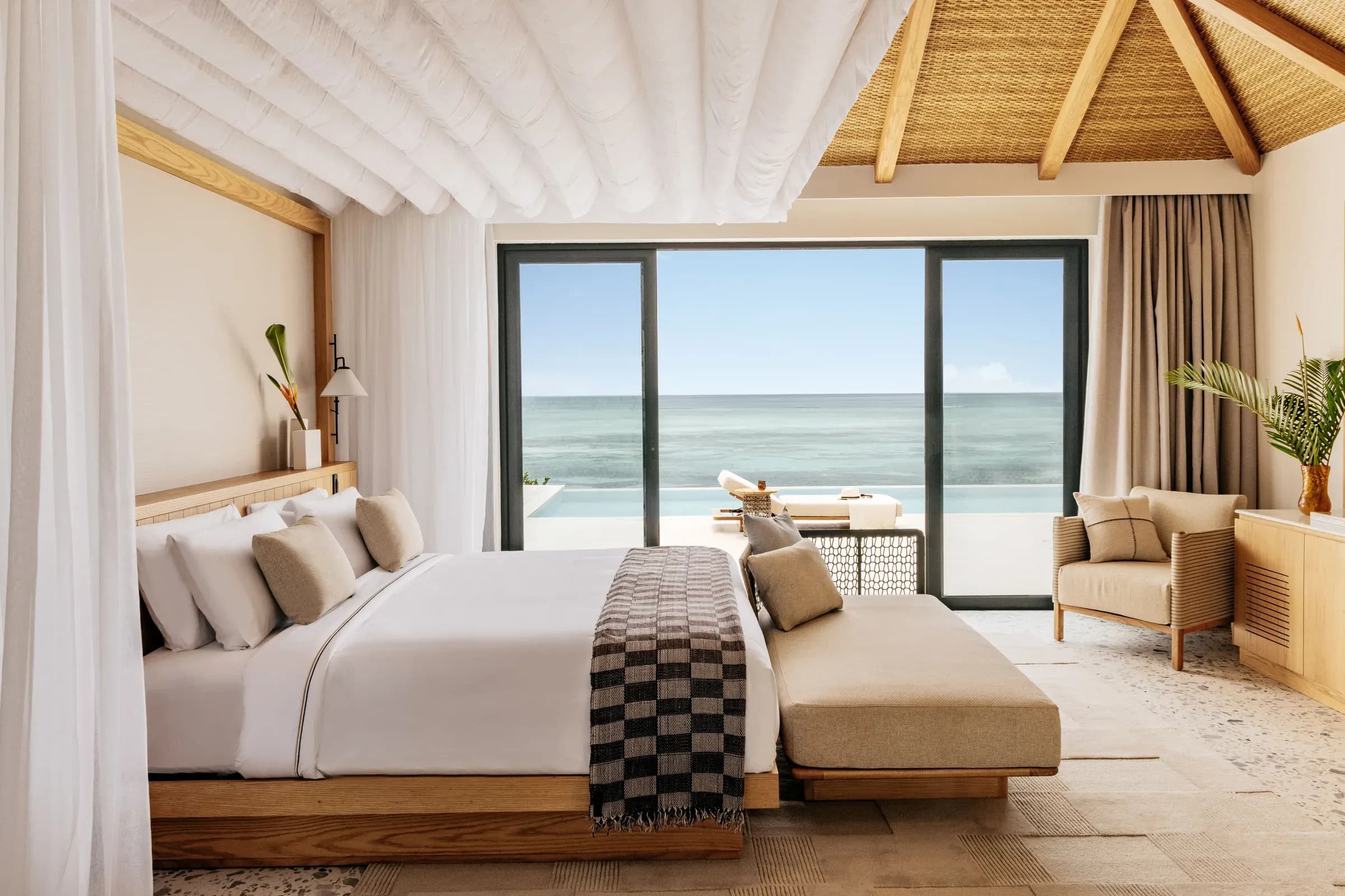 The Level 1 Bedroom Ocean Villa with infinity pool and Balinese bed at Meliá Zanzibar