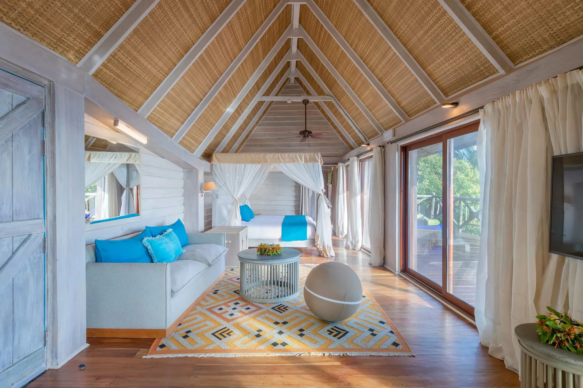 The Level Beach Romance Pavilion bungalow among the palm trees at Meliá Zanzibar