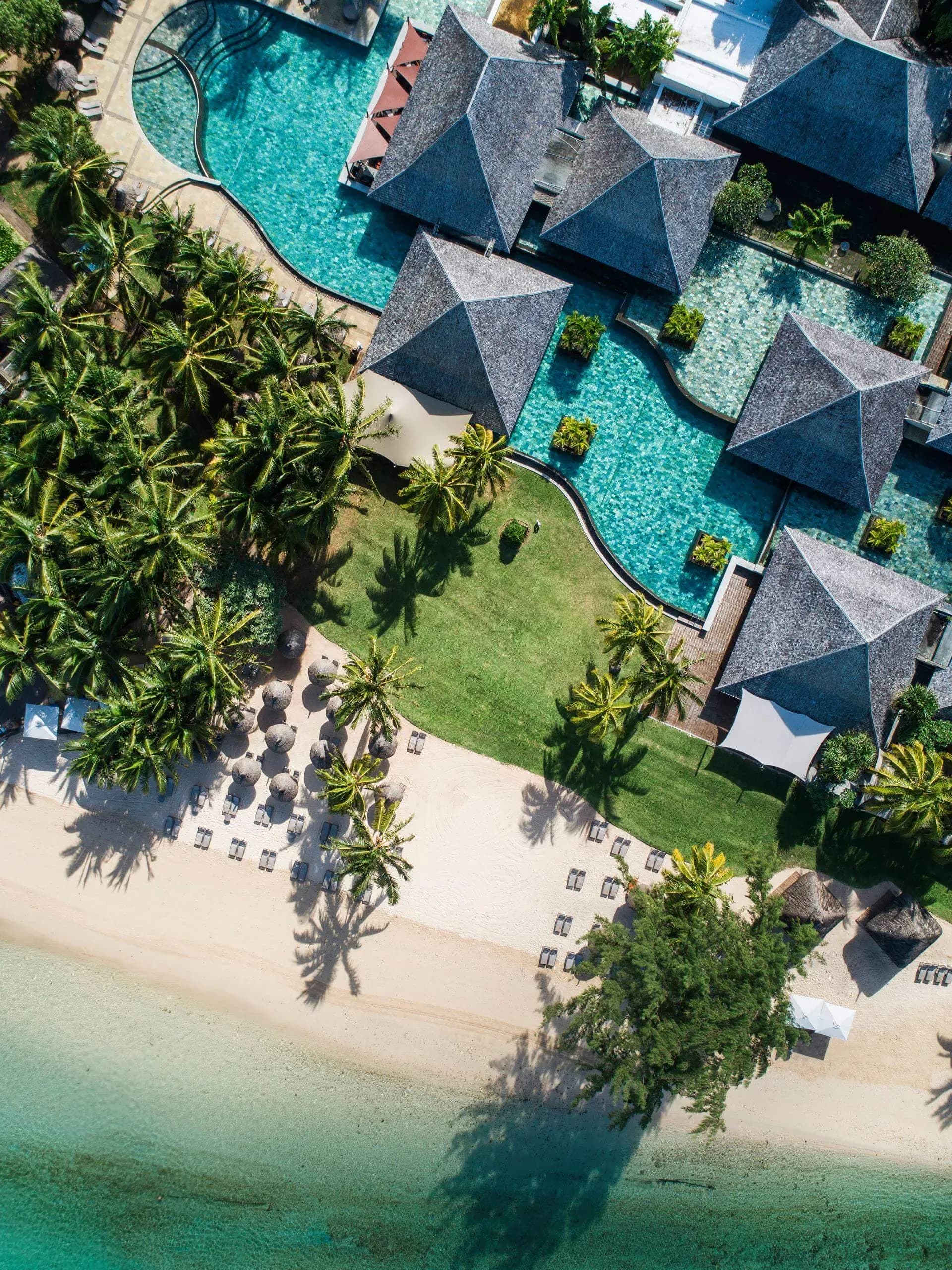Aerial view over the gardens, pools and coastline at Heritage Awali