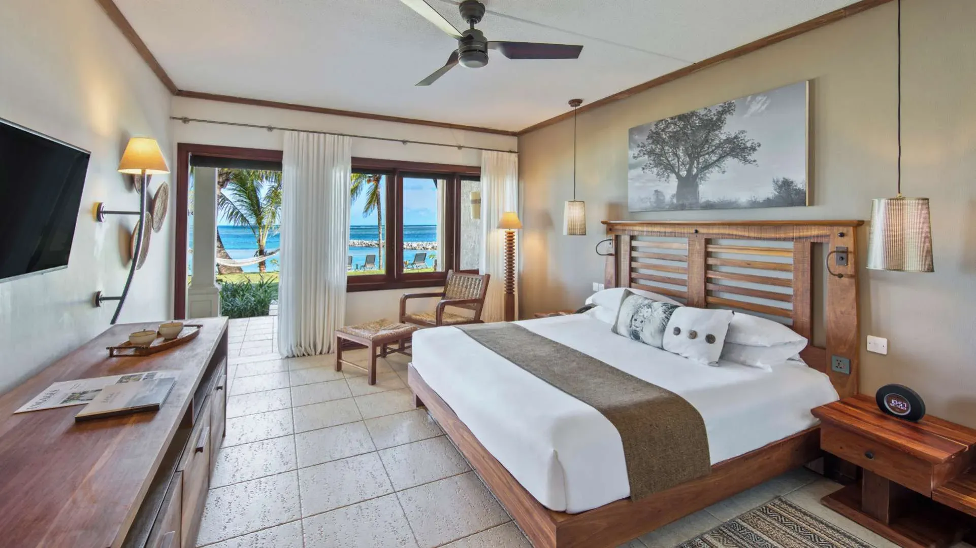 Senior Suite bedroom with direct beach access at Heritage Awali