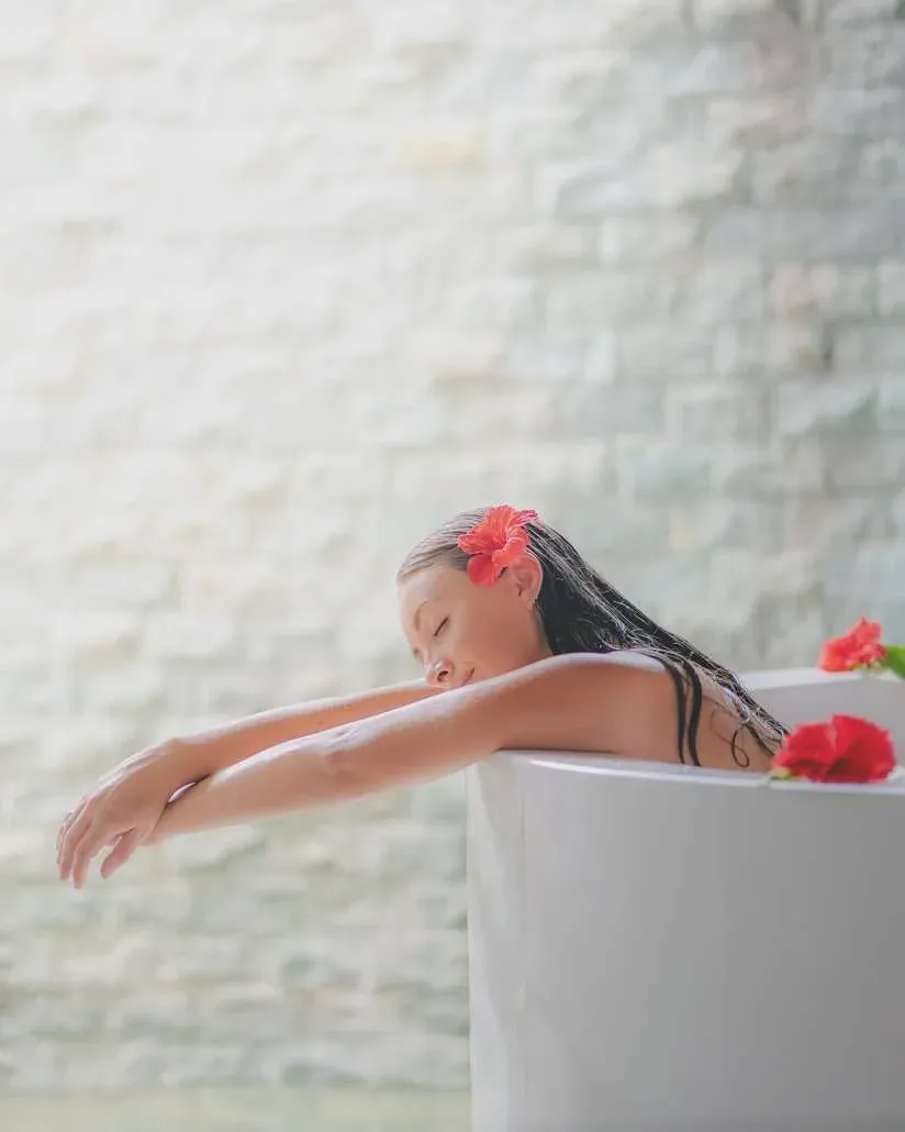Guest relaxing in a treatment bath at Hideaway Spa, Hideaway Beach Resort & Spa