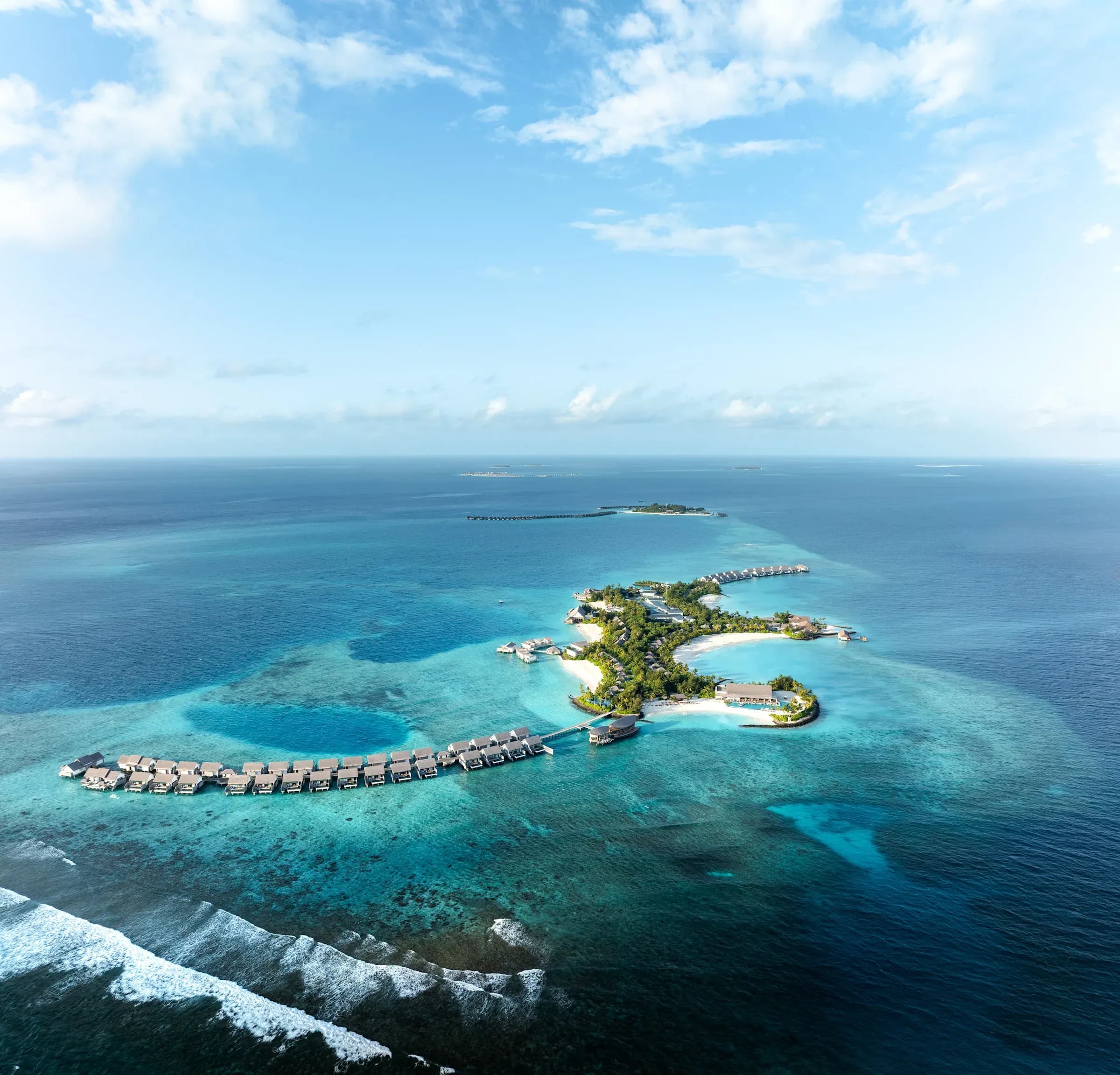 Aerial view of Hilton Maldives Amingiri Resort & Spa's overwater villas and turquoise lagoon, North Malé Atoll