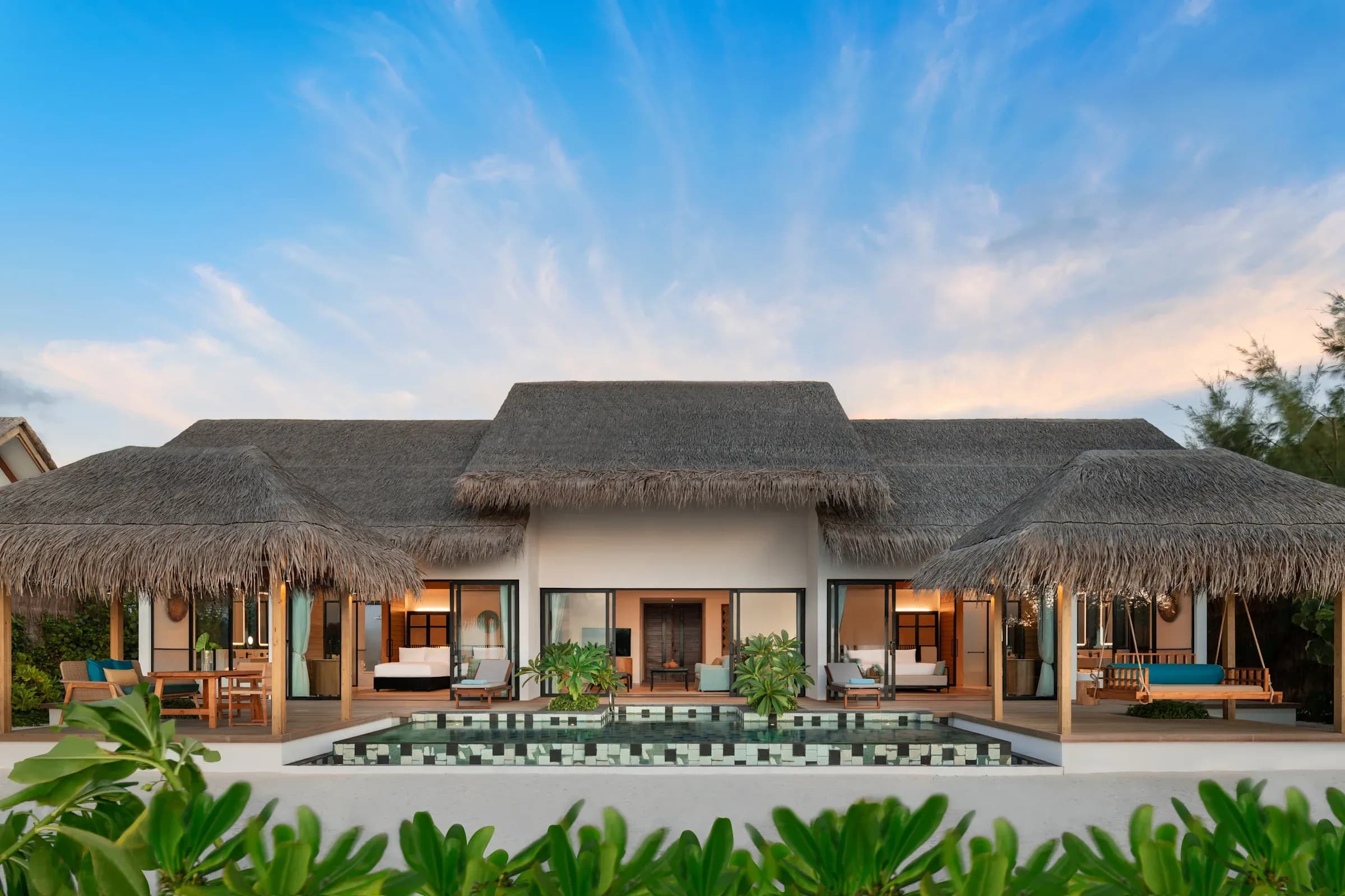 Two-Bedroom Beach Pool Villa exterior with shared pool at Hilton Maldives Amingiri