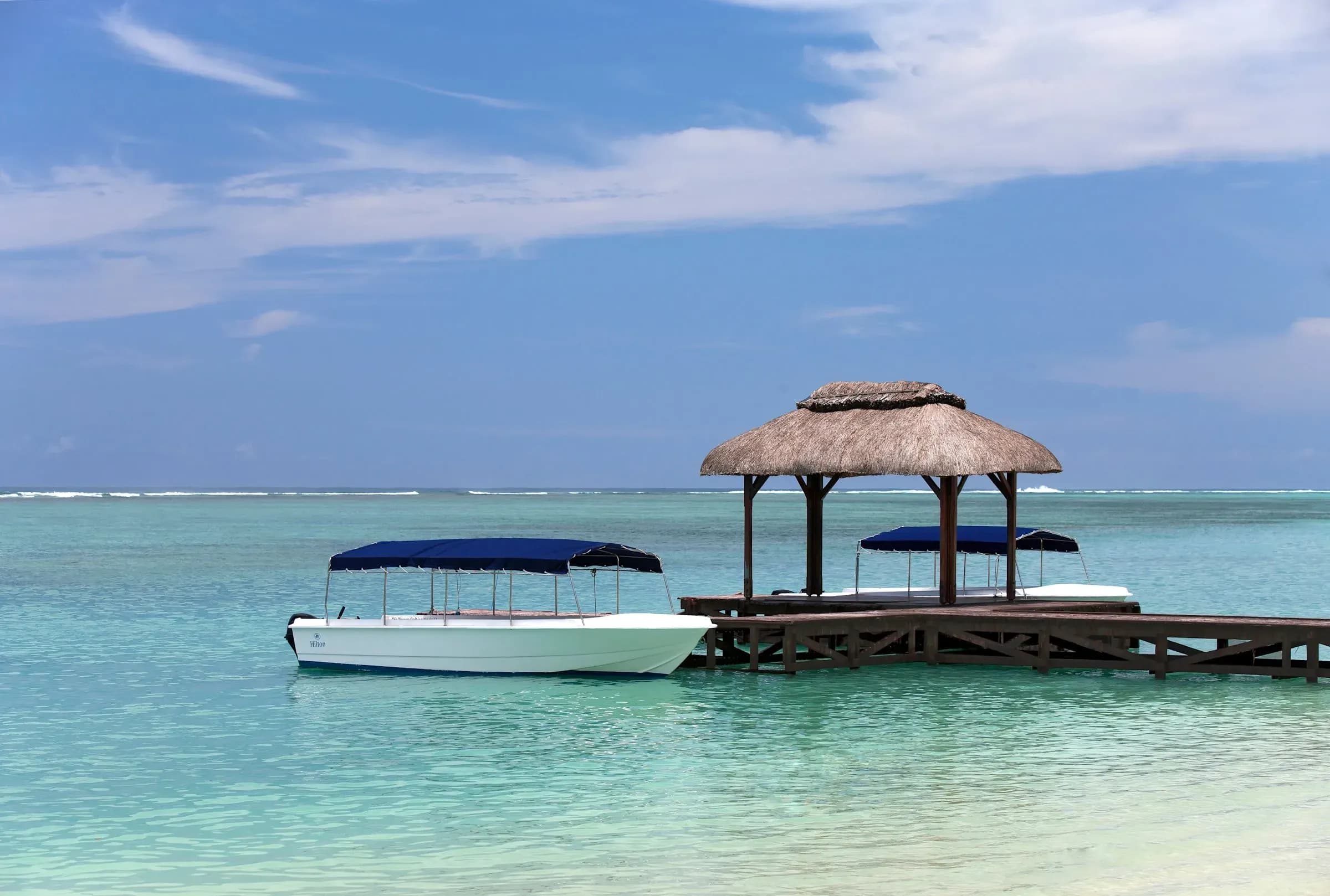 Jetty by day used for water sports at Hilton Mauritius Resort & Spa