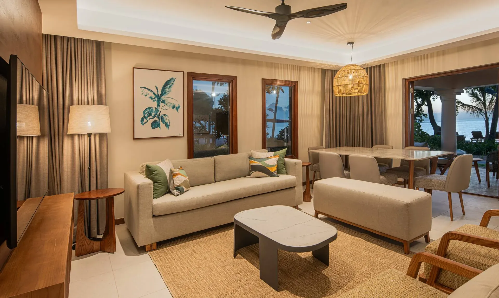 Beachfront Family Suite lounge at dusk at Hilton Mauritius Resort & Spa