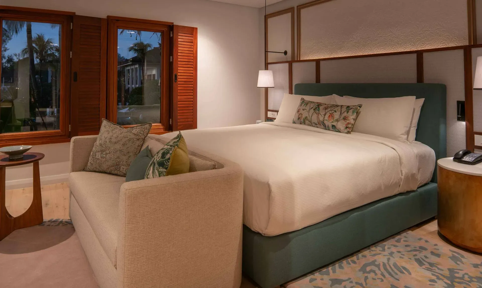 Presidential Suite bedroom at dusk at Hilton Mauritius Resort & Spa