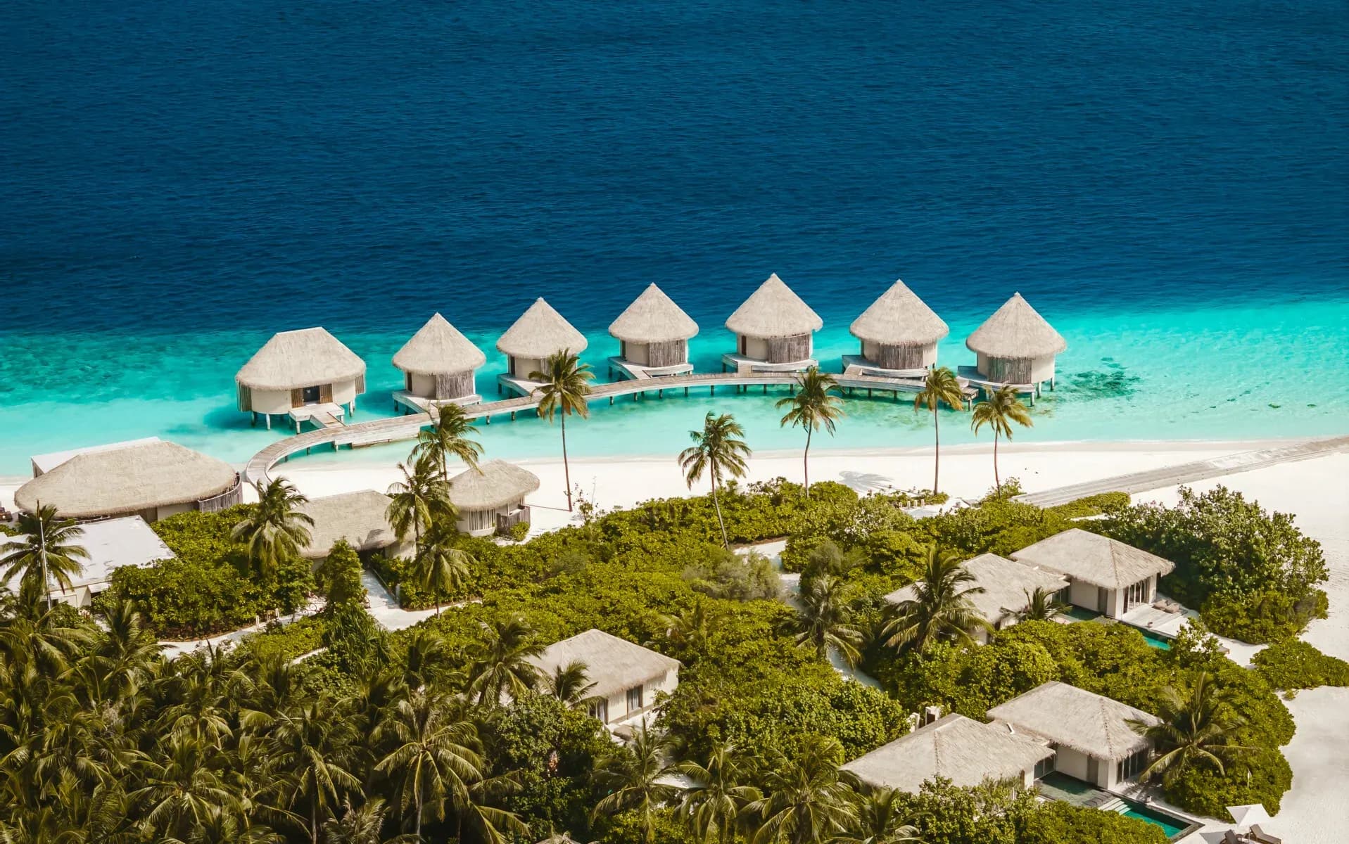 Aerial view of InterContinental Maldives Maamunagau Resort's overwater villas and lagoon, Raa Atoll