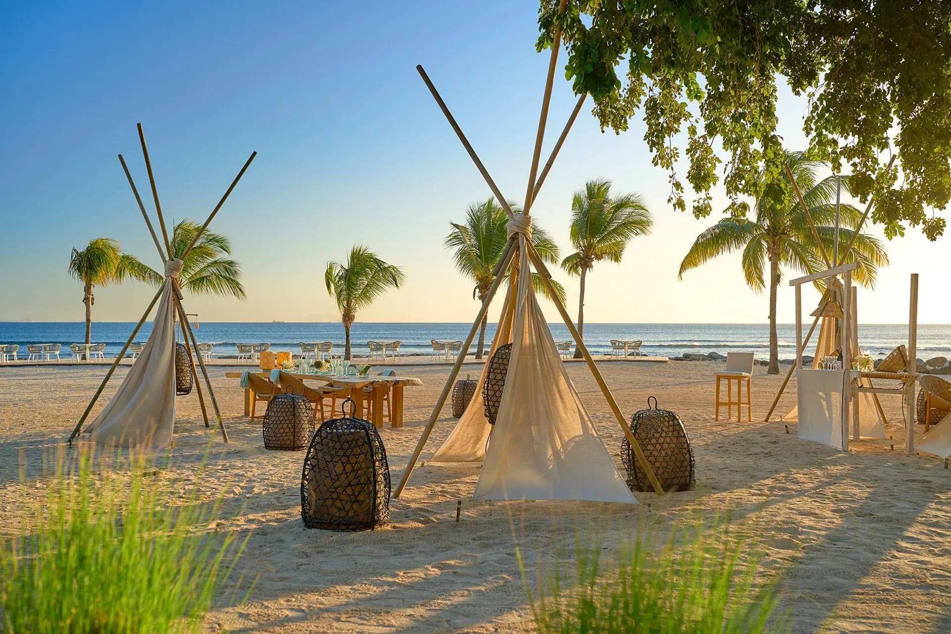 Teepee-style beachfront dining setup at sunset at InterContinental Mauritius Resort Balaclava Fort