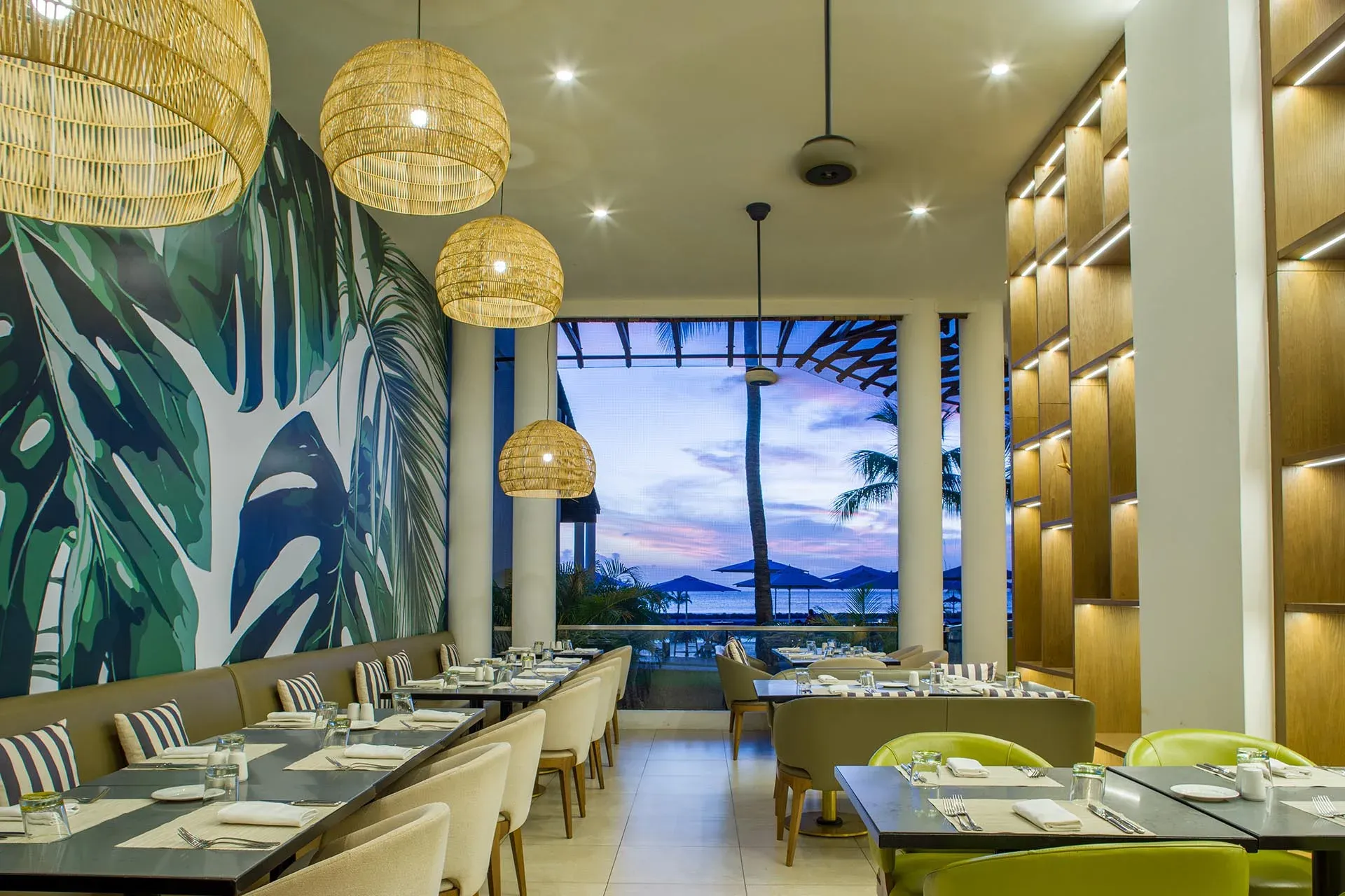 Senso restaurant terrace with tropical mural and sunset sea view at InterContinental Mauritius Resort Balaclava Fort
