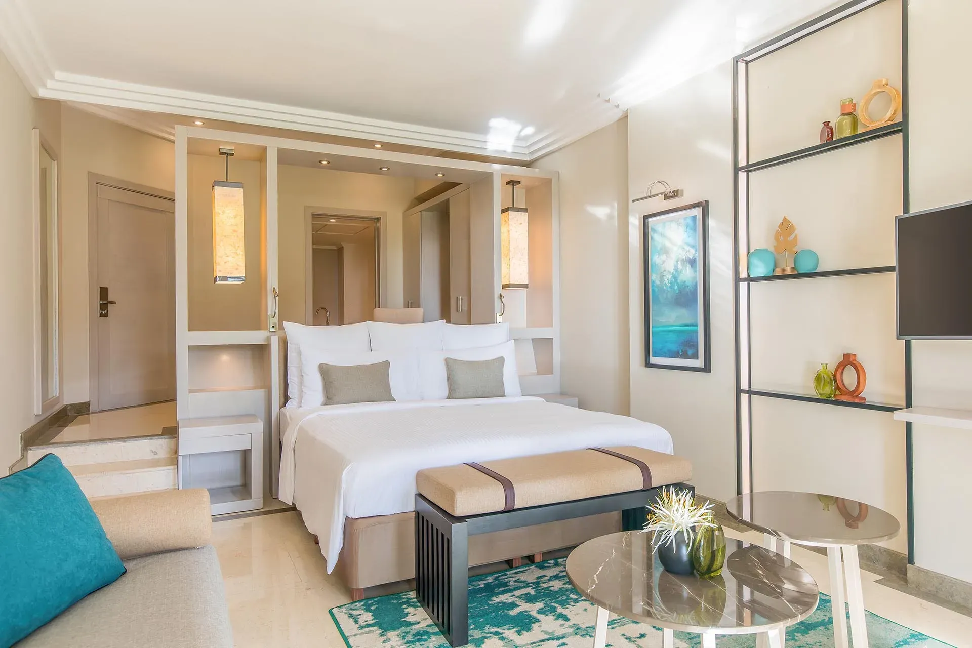 Deluxe Room bedroom with king bed and garden-facing terrace doors at InterContinental Mauritius Resort Balaclava Fort