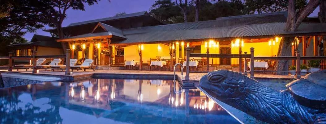 Main swimming pool and Castaway Bar at dusk, JA Enchanted Island Resort