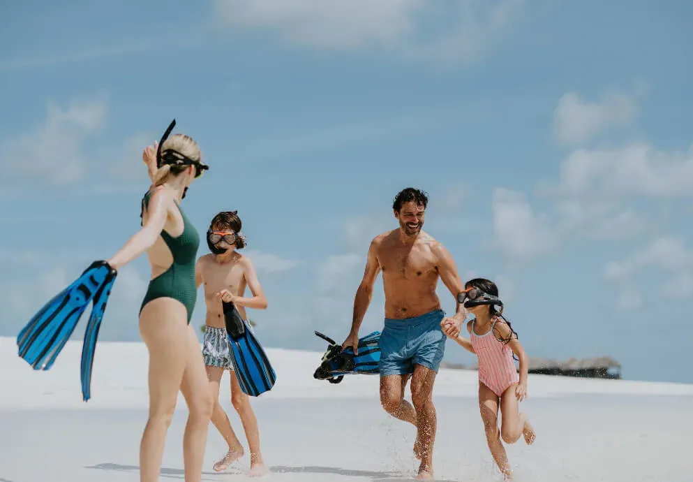 Family snorkelling off the beach at JA Manafaru