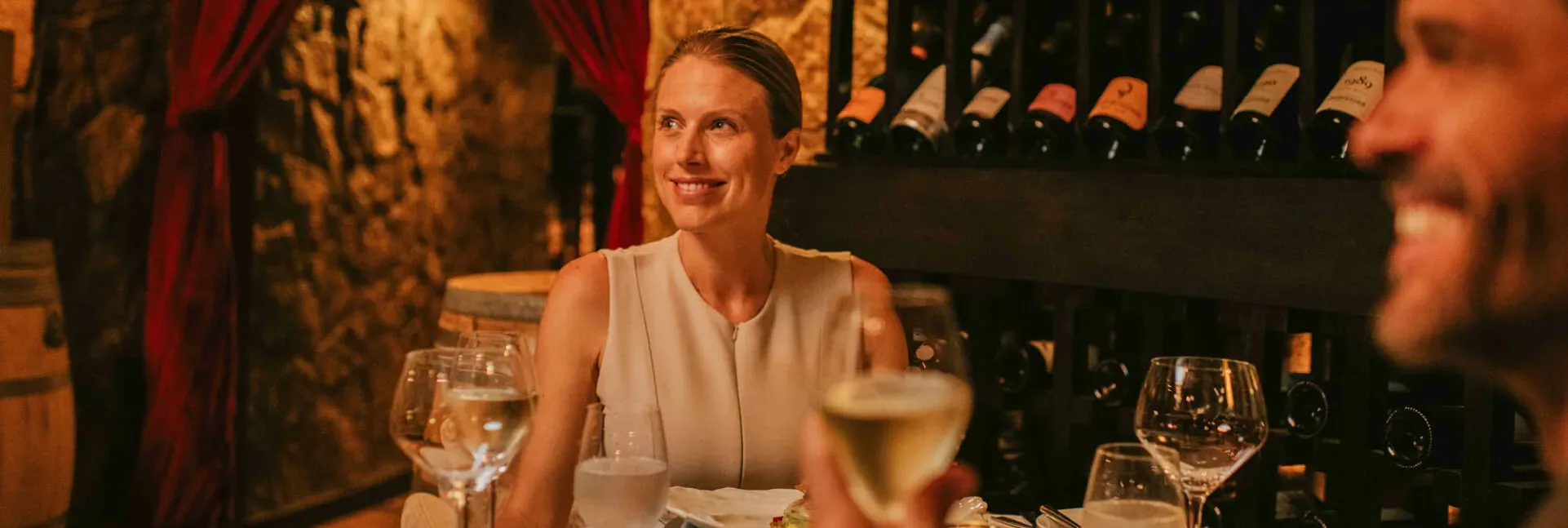 Guests dining at The Cellar, JA Manafaru's underground volcanic-rock wine cellar restaurant