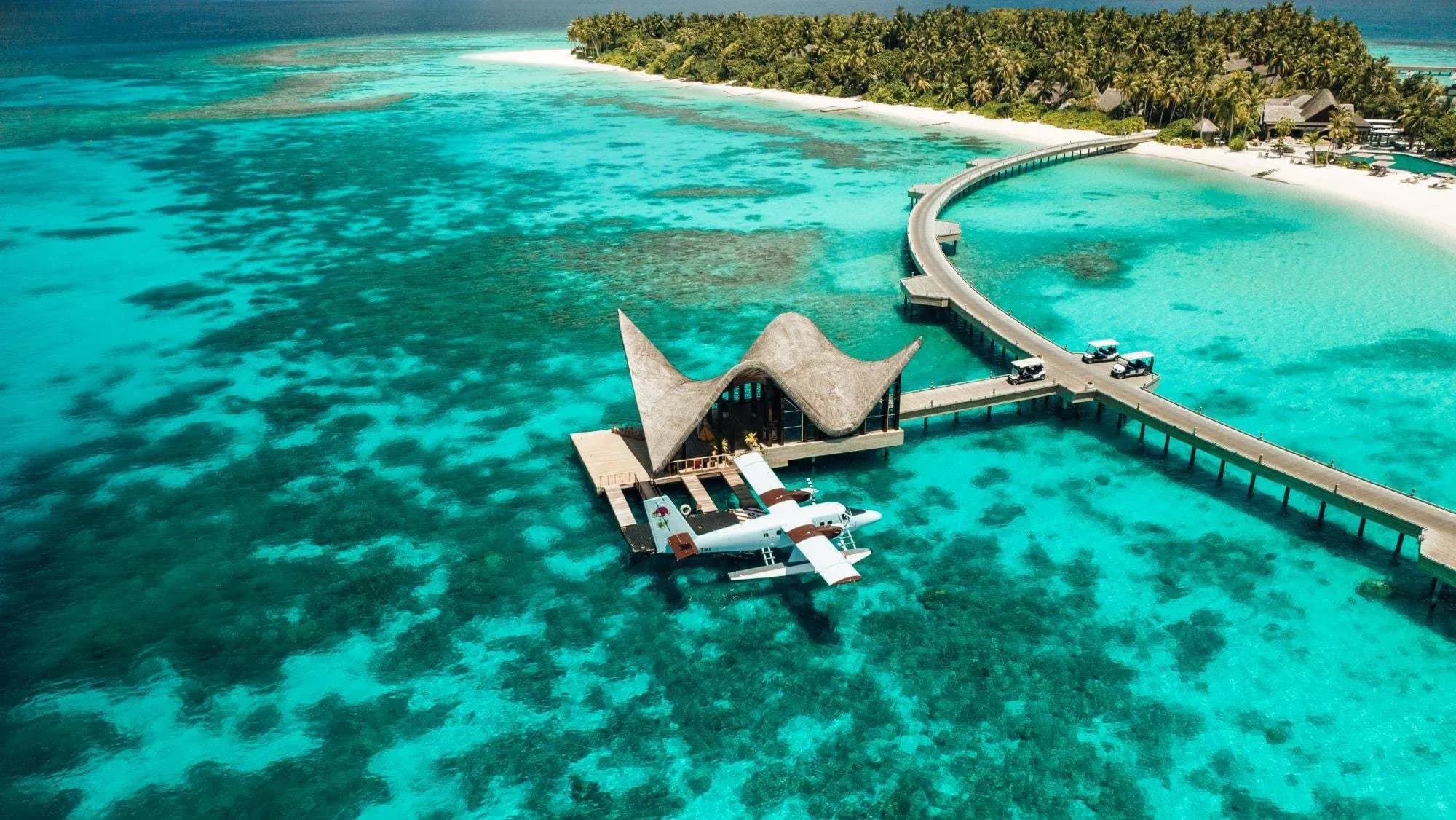 Aerial view of JOALI Maldives' overwater villas and lagoon, Muravandhoo Island, Raa Atoll