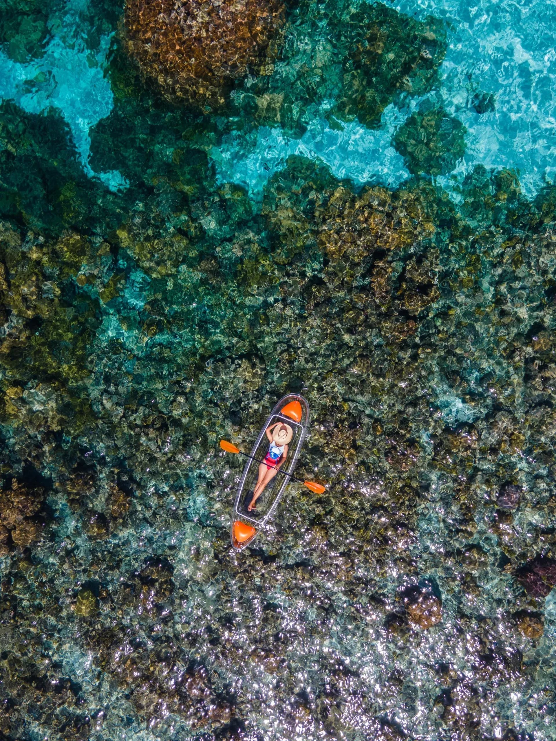 Glass-bottom kayak over the house reef at Kagi Maldives Resort & Spa