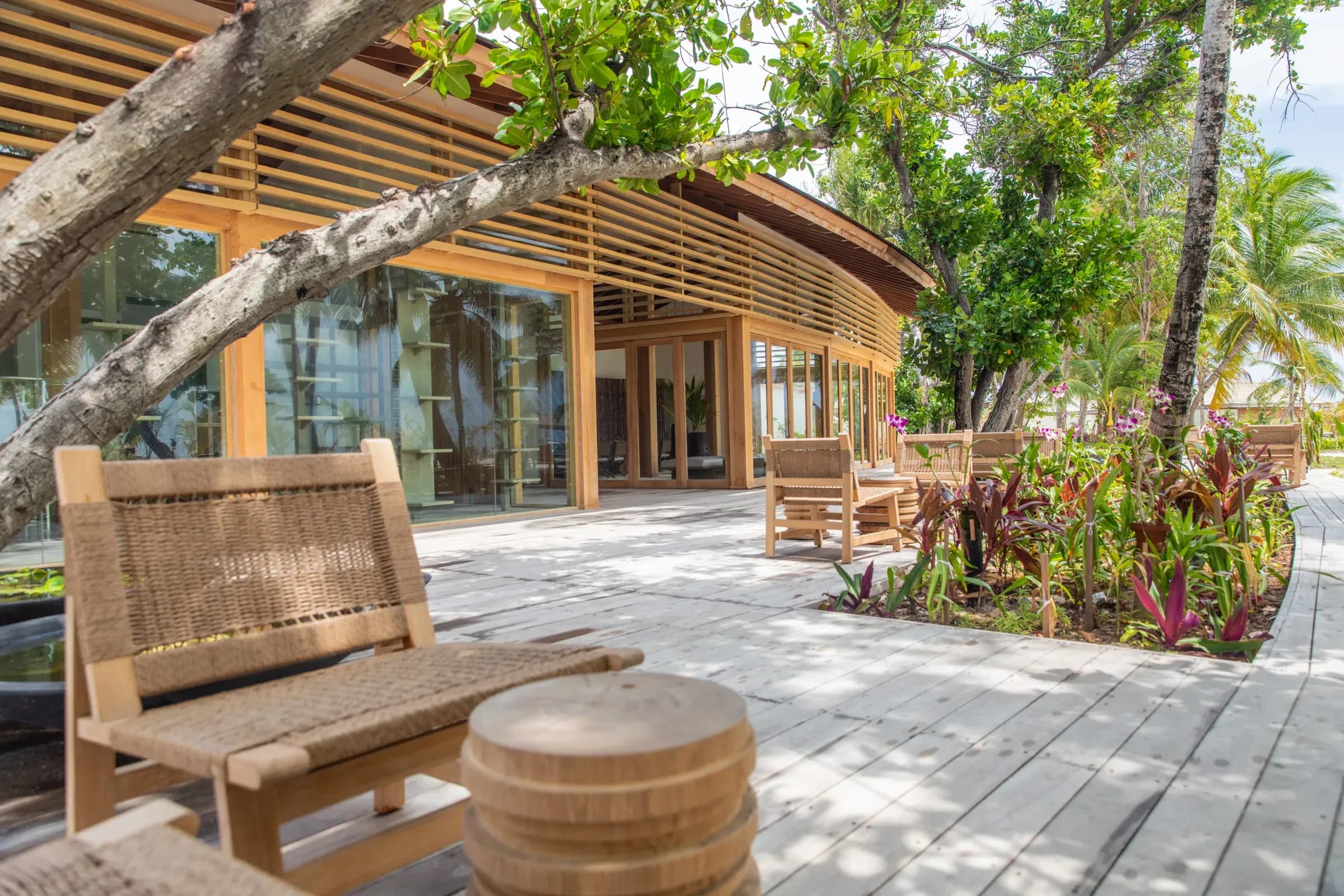 Zen-inspired timber reception pavilion set among palms at Kagi Maldives Resort & Spa