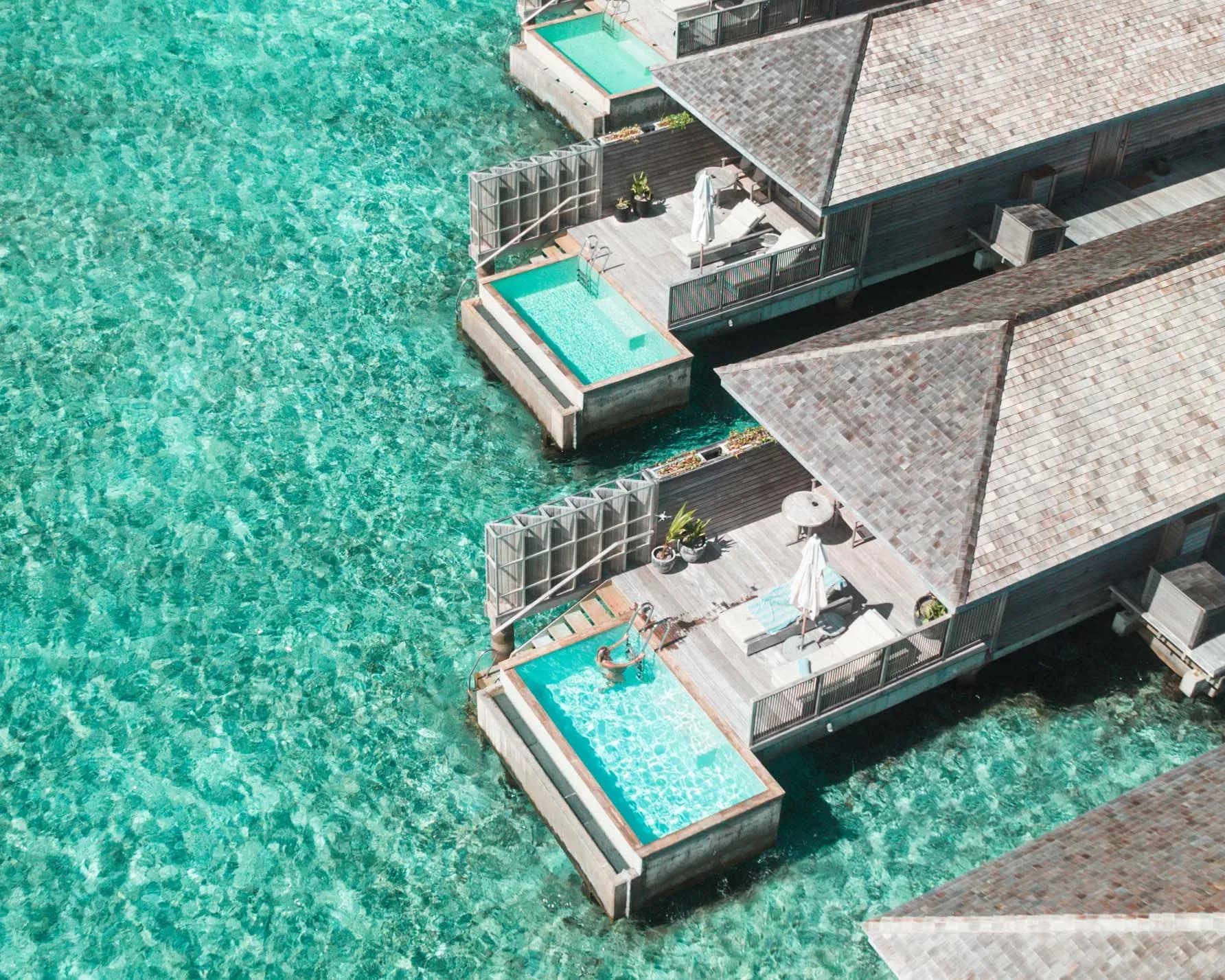 Overwater Pool Villa plunge pools and deck over the turquoise lagoon at Kagi Maldives