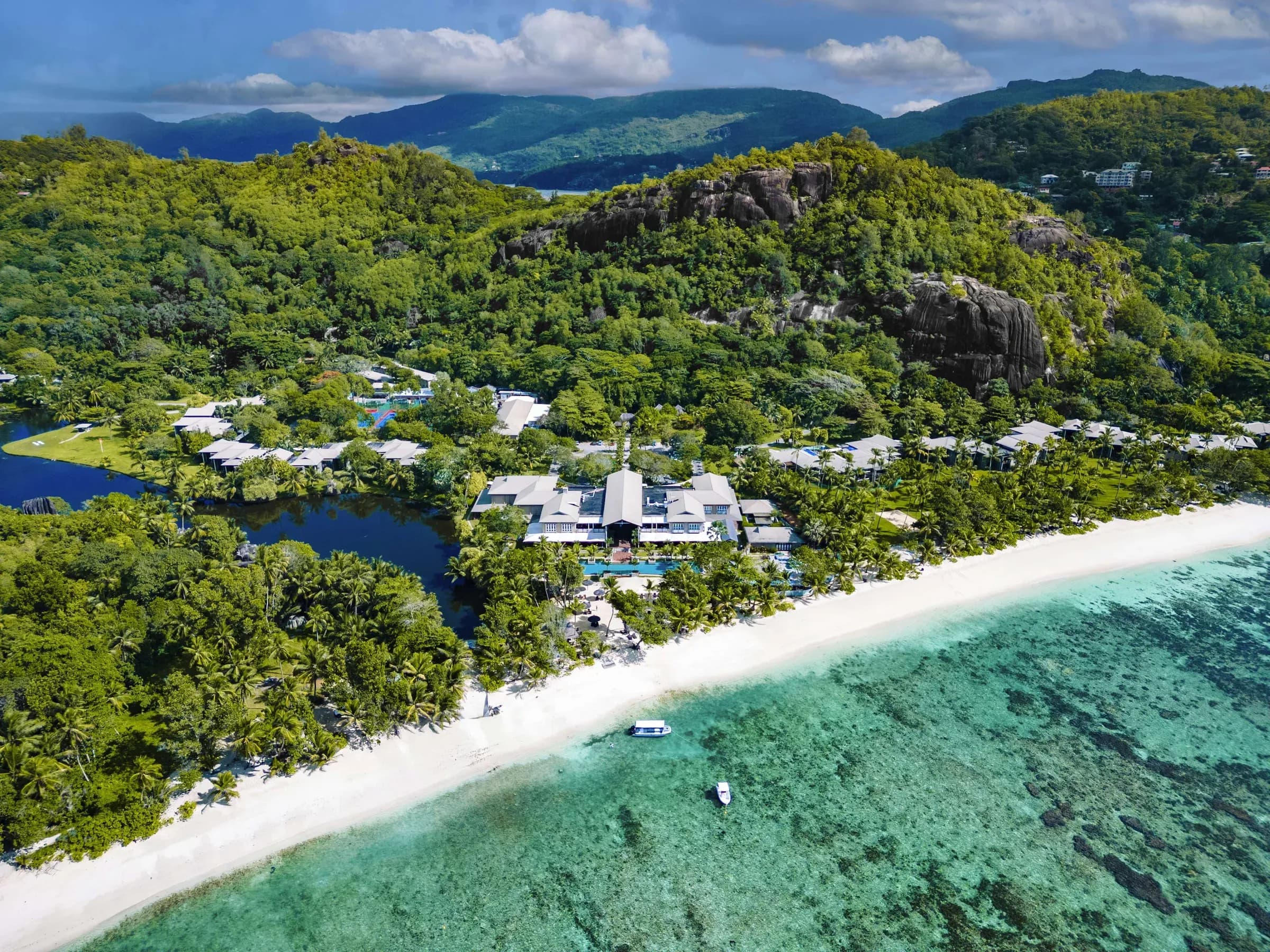 Aerial view of Kempinski Seychelles Resort's beach, gardens and Plantation-style pavilions at Baie Lazare, Mahé