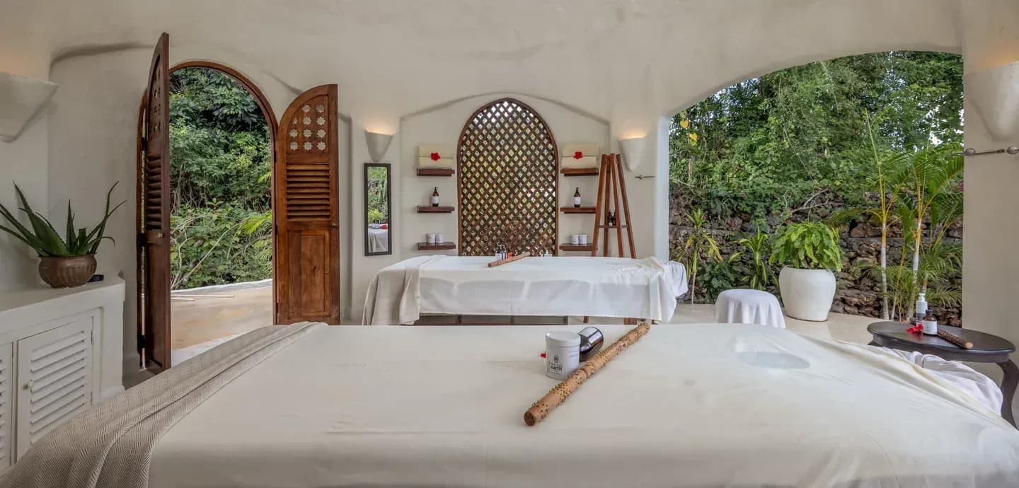 Kilindi Spa treatment pavilion with two massage beds opening onto the tropical garden