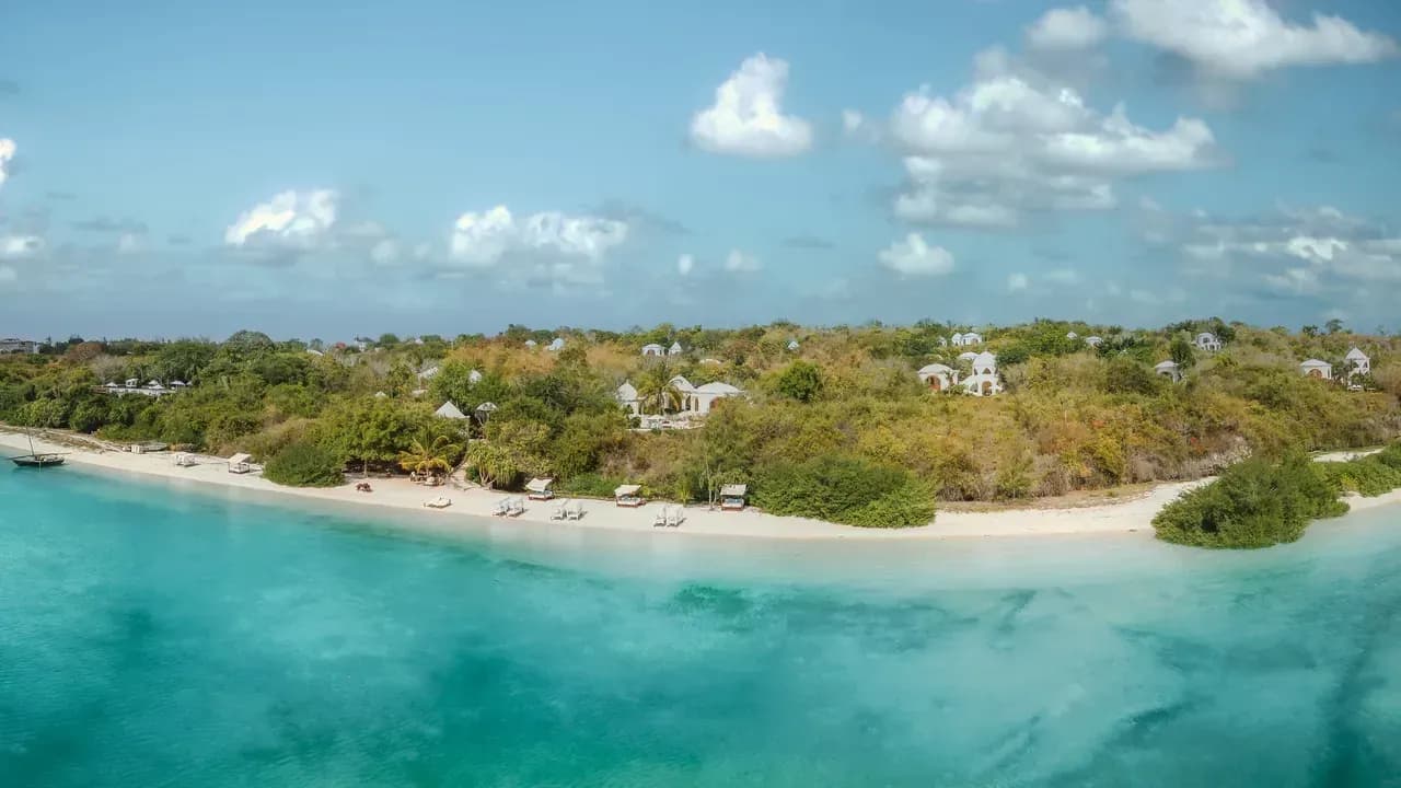 Aerial view of Kilindi Zanzibar's white-domed pavilions set among tropical gardens along the Kendwa shoreline