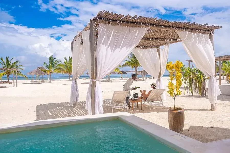 Poolside cabana with sun loungers beside the beach at Konokono Beach Resort