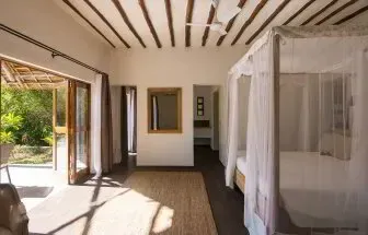 Garden View Villa bedroom opening onto its private garden at Konokono Beach Resort