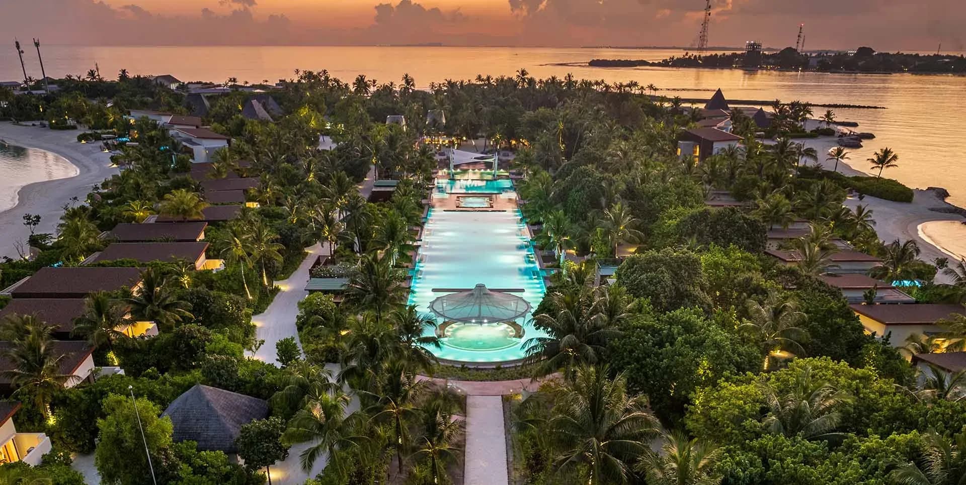 The 150-metre swimming pool at dusk, Kuda Villingili Resort Maldives