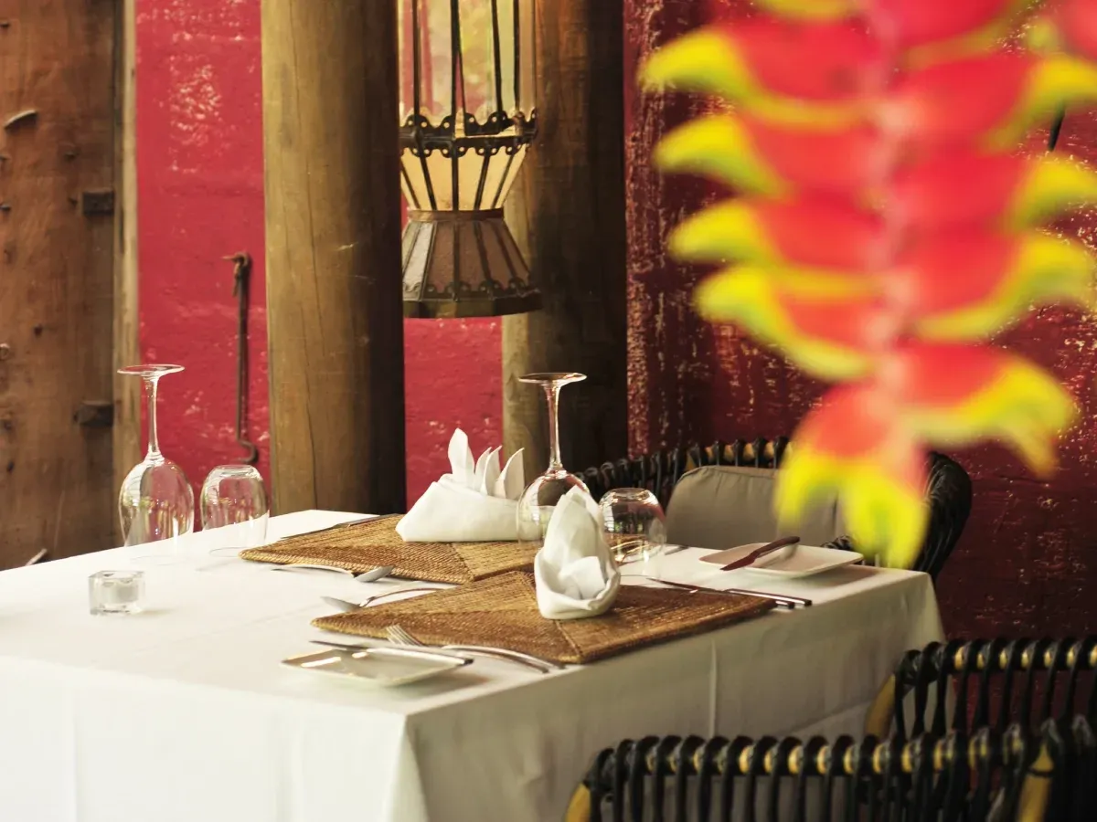 Elegant table setting with heliconia flowers at Makak Restaurant, Lakaz Chamarel Exclusive Lodge
