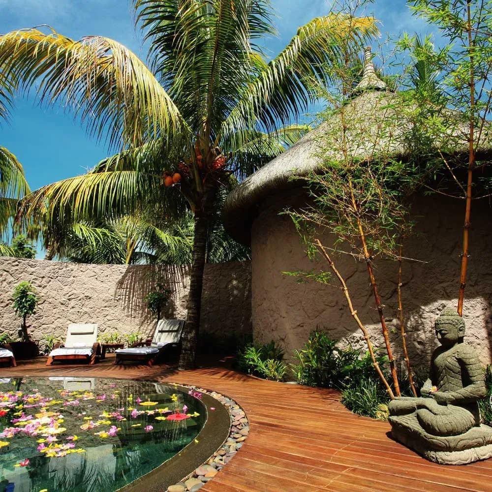 Thatched spa pavilion and reflection pool at Le Cardinal Exclusive Resort