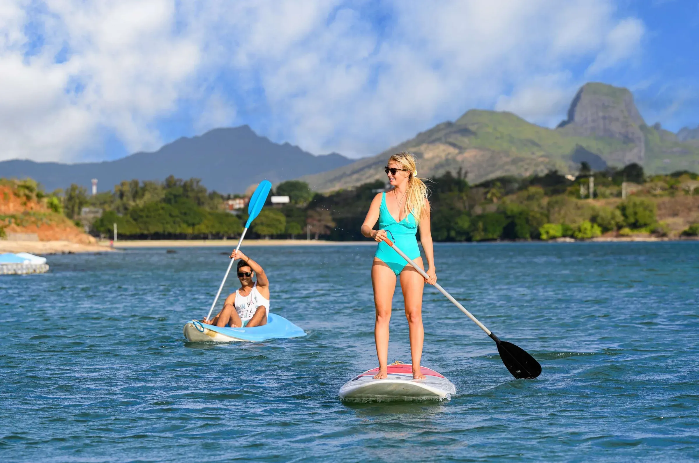 Guests kayaking and stand-up paddleboarding in Turtle Bay at Le Jadis