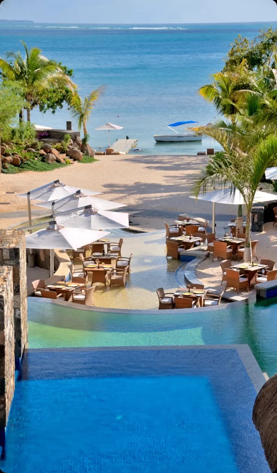 Passion Creole poolside restaurant with sandy floor and swim-up bar at Le Jadis