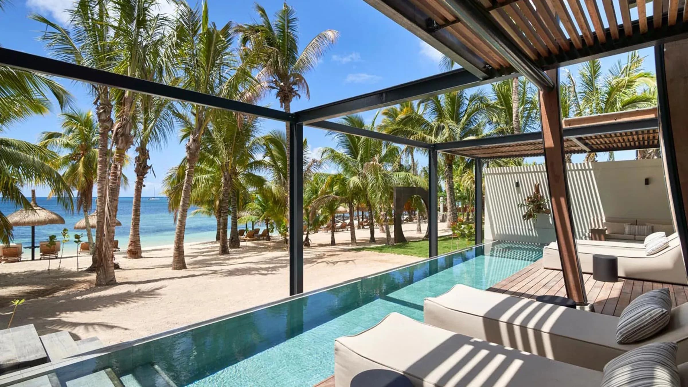 Beachfront pool villa terrace with palm trees and private plunge pool at LUX* Grand Baie, Mauritius