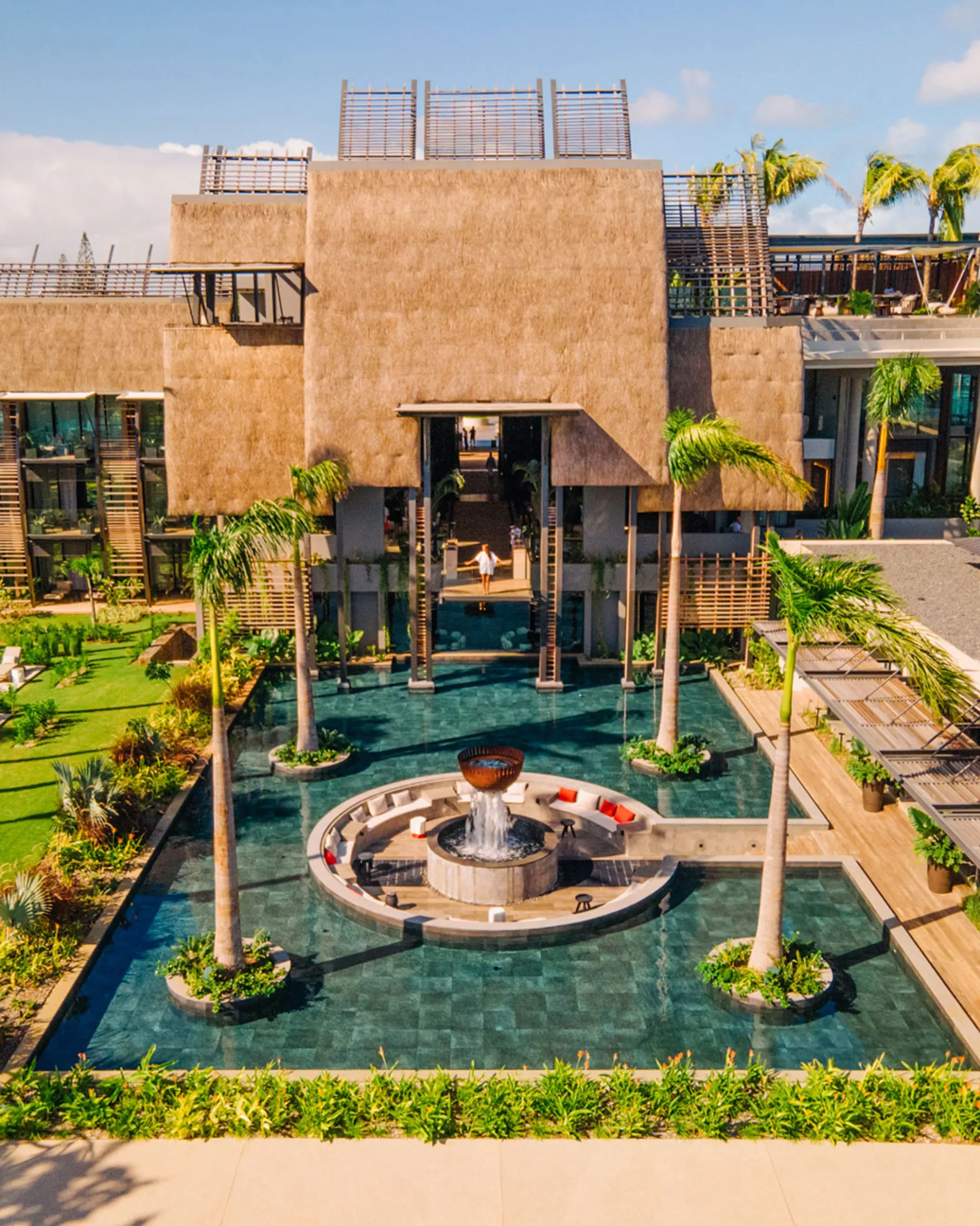 Aerial view of the courtyard reflecting pool and thatched pavilions at LUX* Grand Baie