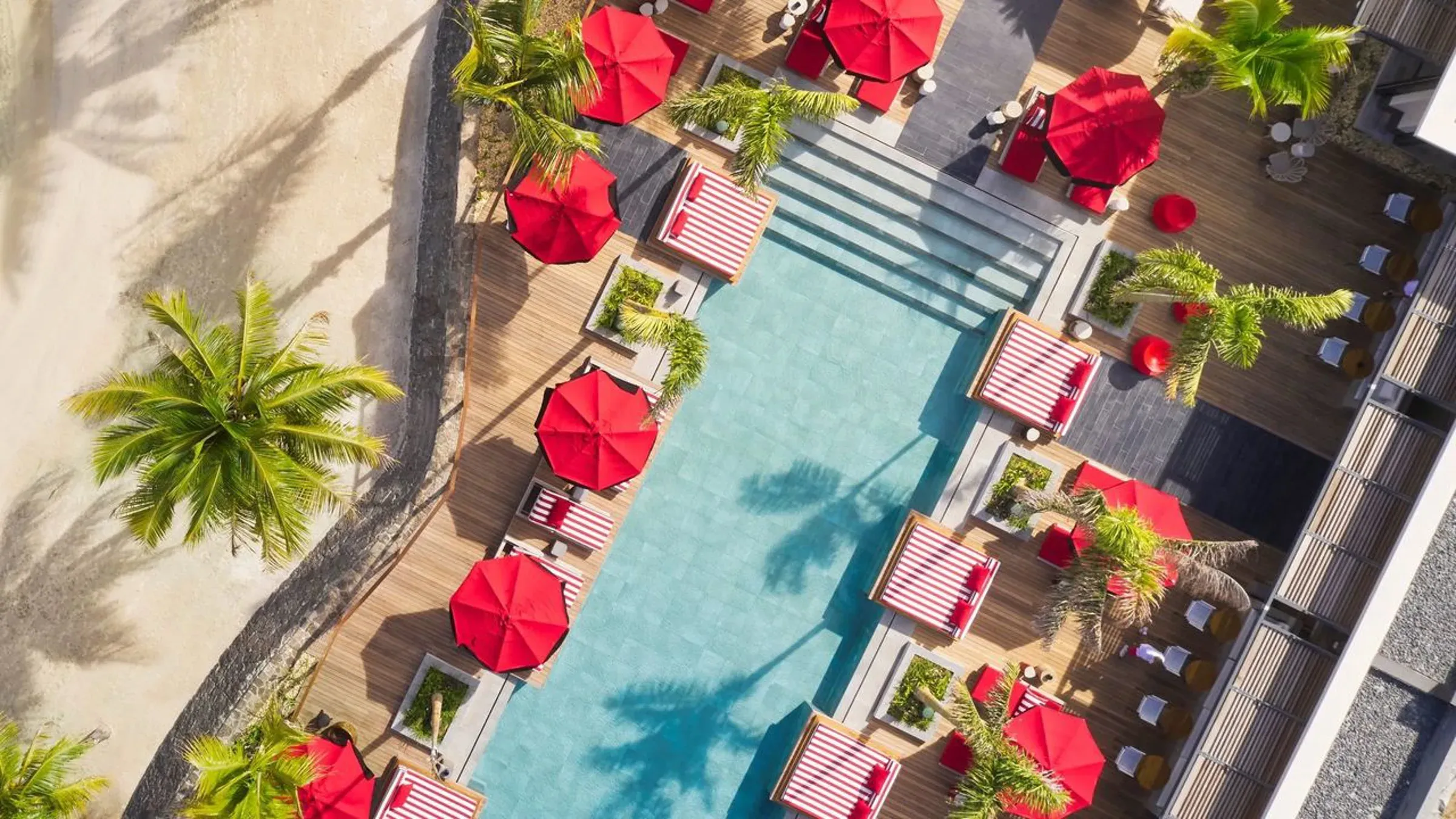Aerial view of Beach Rouge's pool deck and sun loungers at LUX* Grand Baie