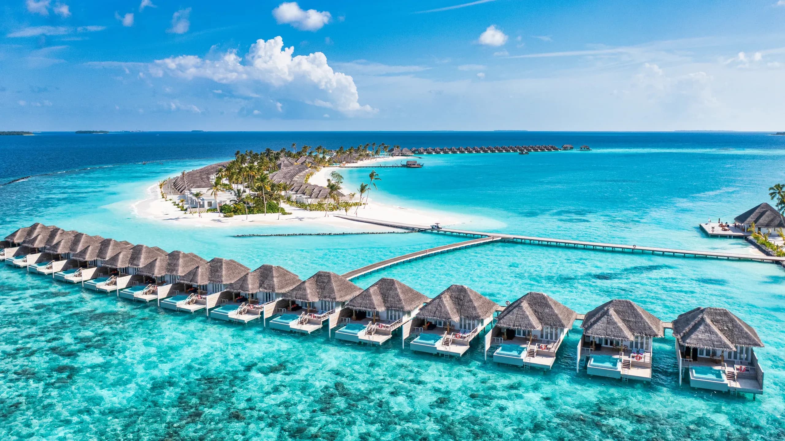 Aerial view of a Maldives atoll with turquoise lagoon