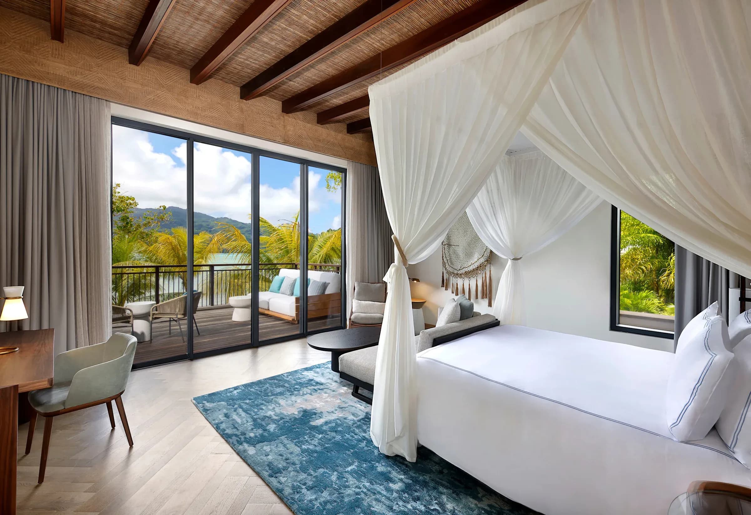King Premium Room with Ocean View, canopy bed and balcony at Mango House Seychelles