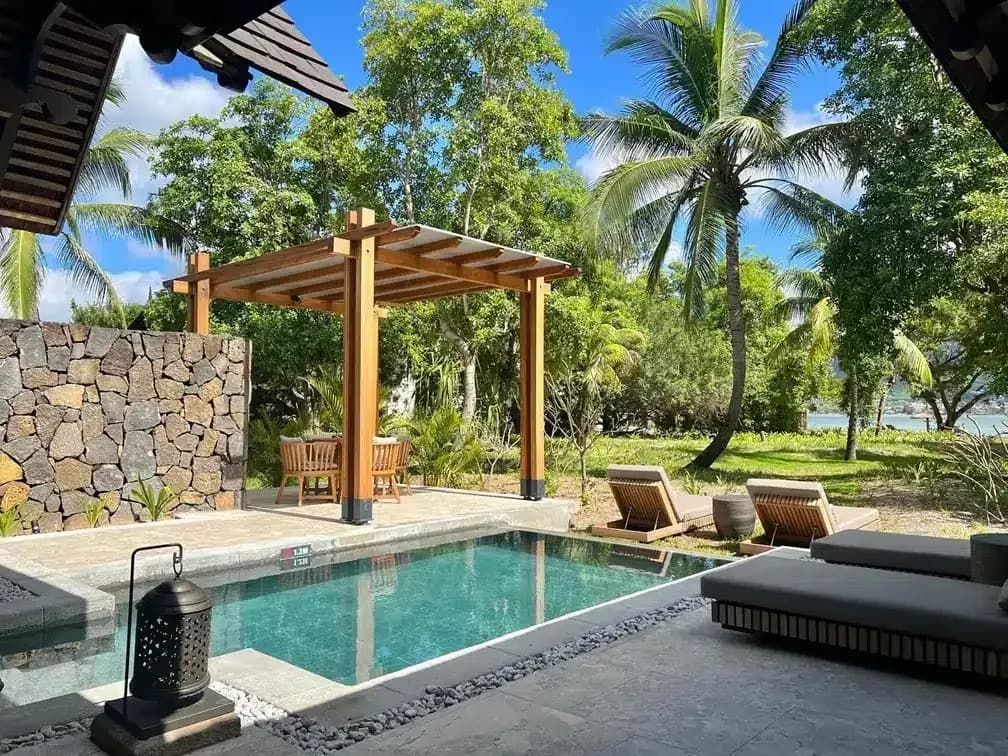 Private pool and pergola of a Beachfront Pool Villa at Maradiva, with the lagoon beyond
