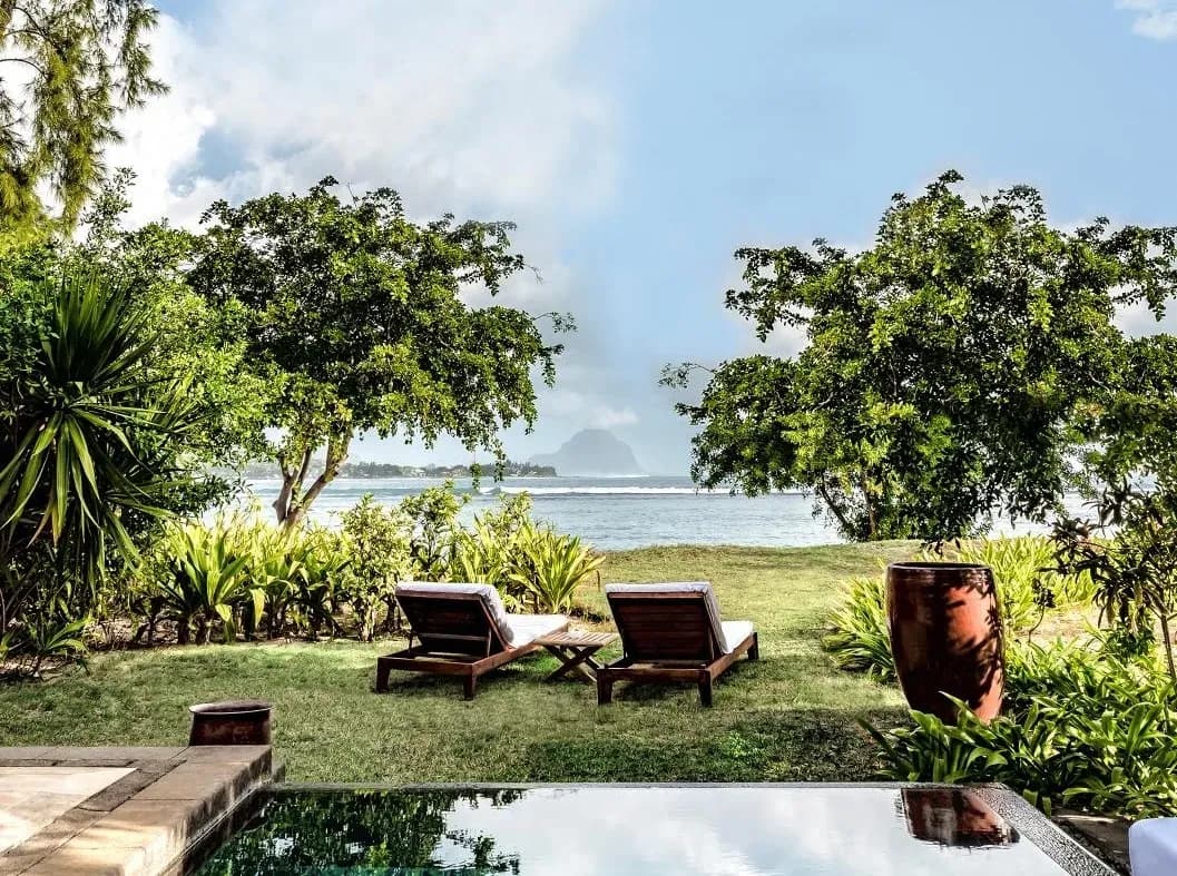 Poolside sun loungers looking out to Le Morne from a Family Beachfront Pool Villa at Maradiva