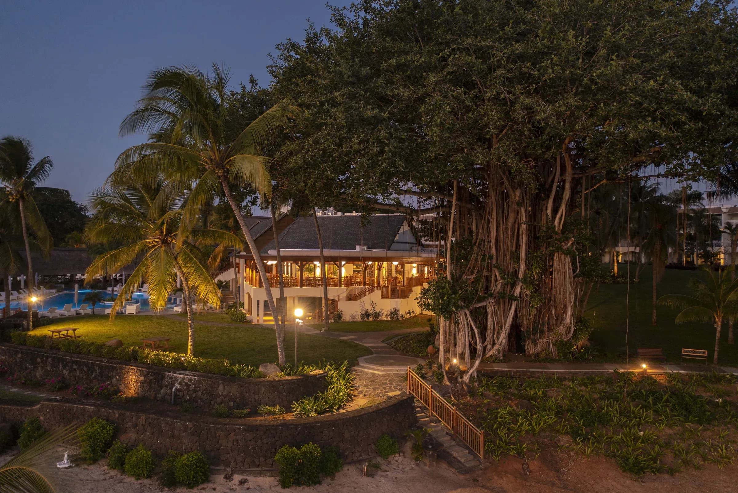 Le Banyan restaurant grounds beneath the tropical trees at Maritim Resort & Spa Mauritius