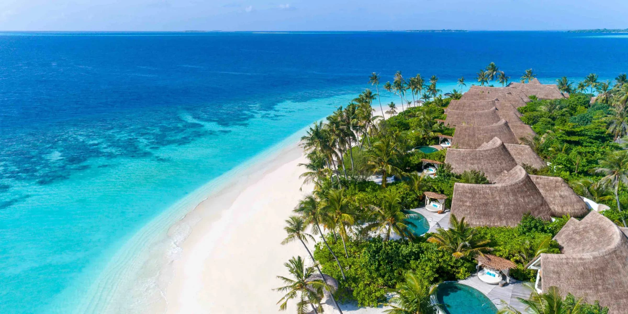 Aerial view of Milaidhoo Island Maldives beach villas and turquoise lagoon, Baa Atoll