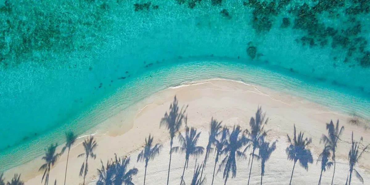 Aerial view of Milaidhoo's white sand beach and coral reef edge
