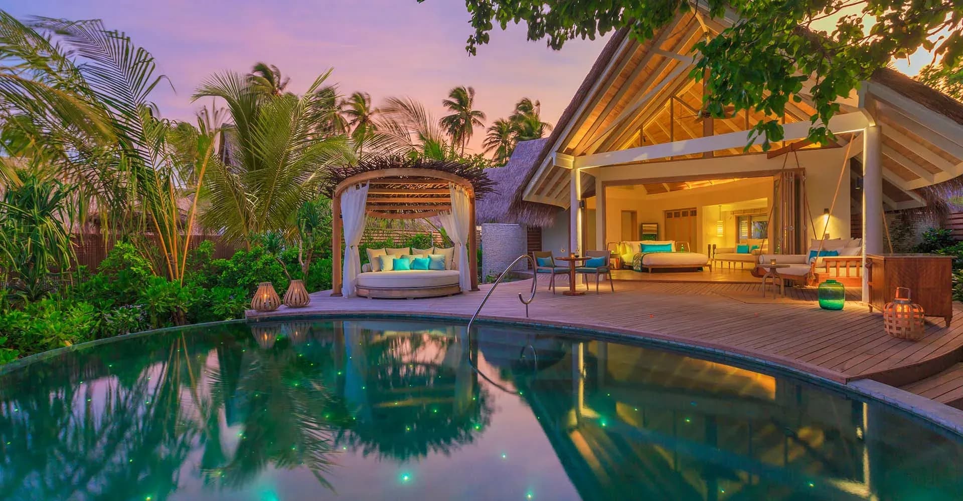 Beach Pool Villa deck and private pool at sunset at Milaidhoo