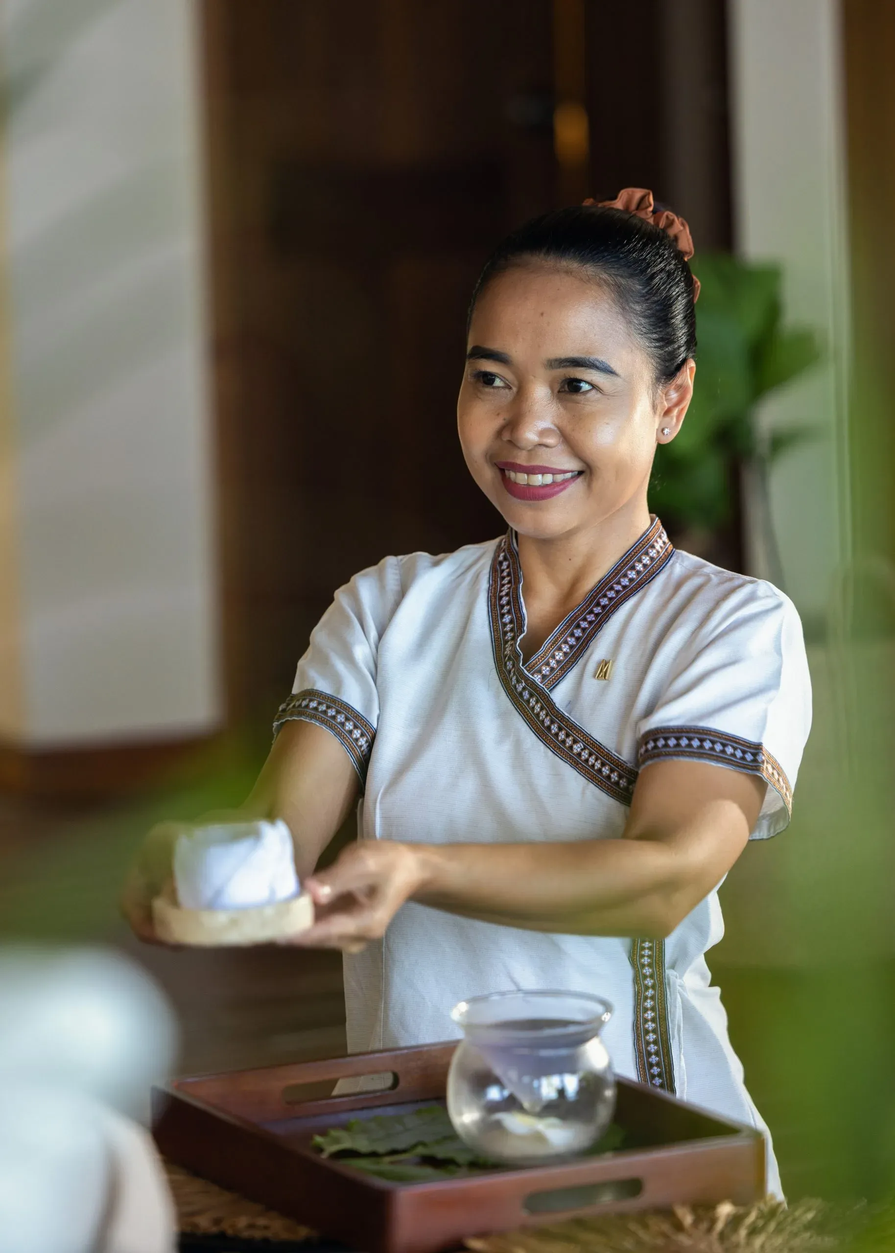 Spa therapist preparing a treatment at Mirihi Spa & Wellness, V Villas Maldives at Mirihi
