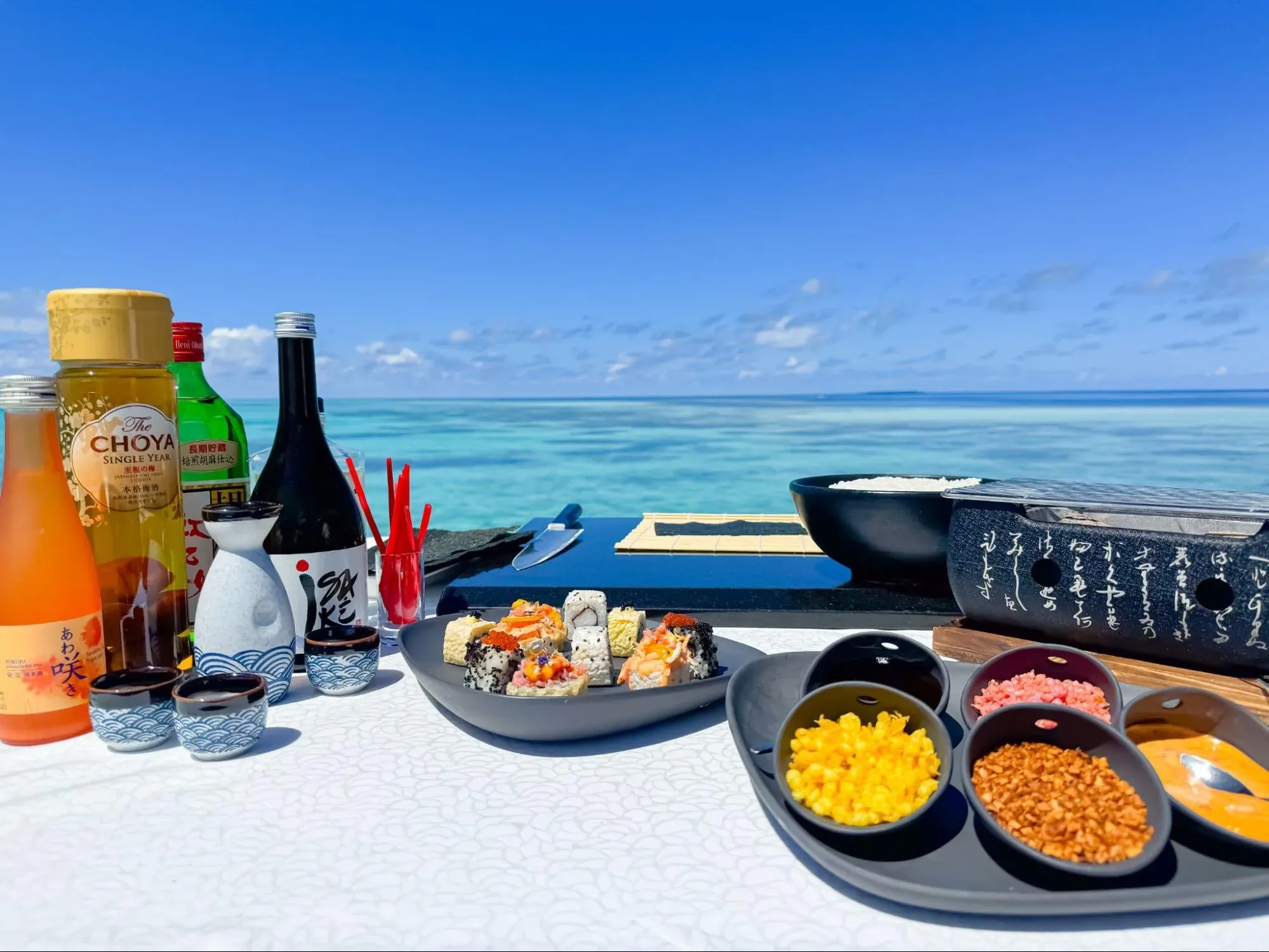 Sushi and sake tasting spread overlooking the lagoon at The Tasting Room, V Villas Maldives at Mirihi