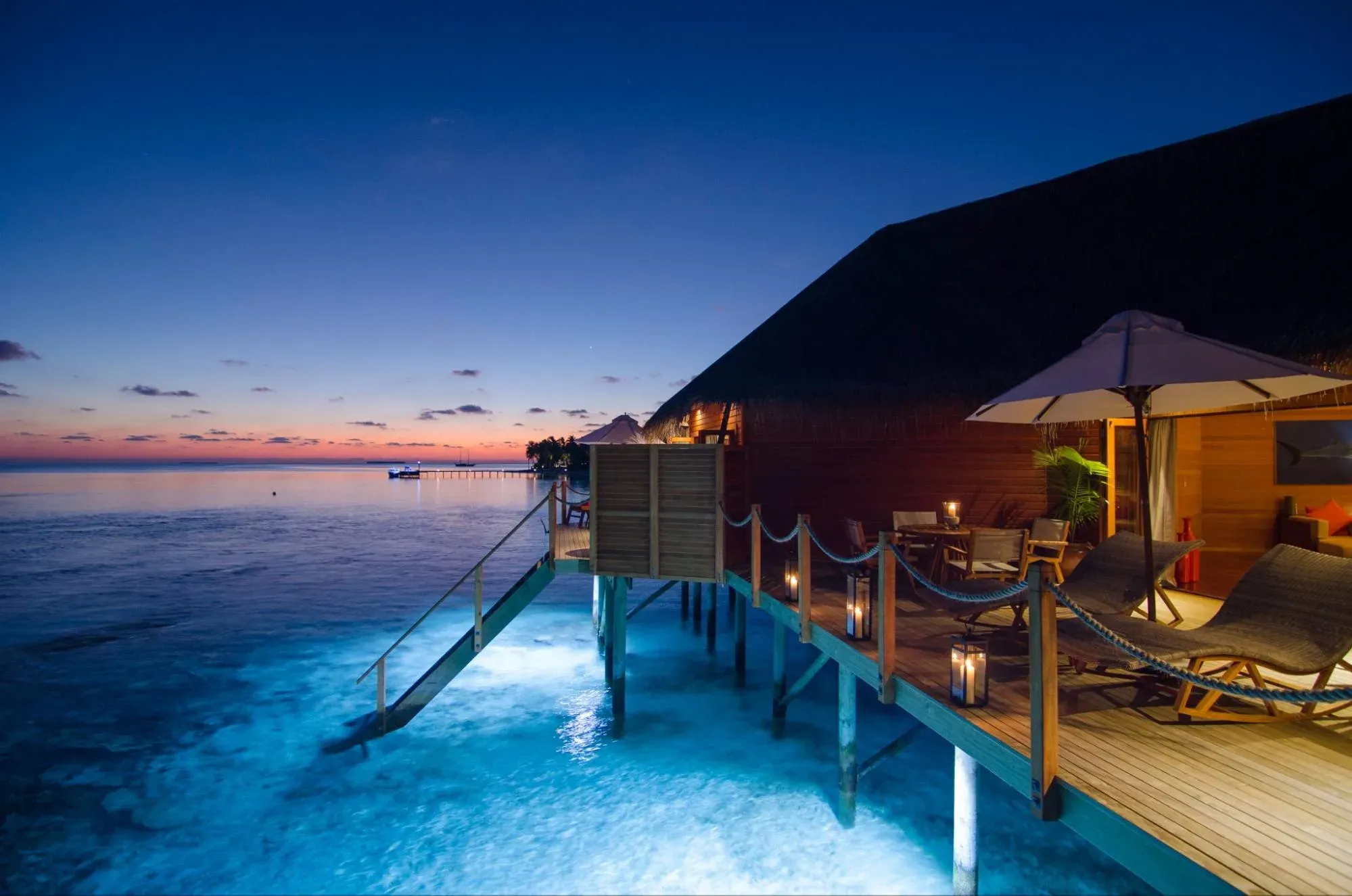 Aerial view of a row of Two Bedroom Water Suites on stilts over the reef at V Villas Maldives at Mirihi