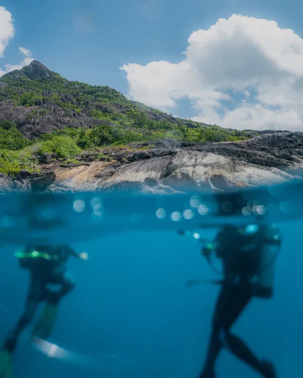 Scuba divers exploring the reef at Niva Labriz Seychelles, Silhouette Island