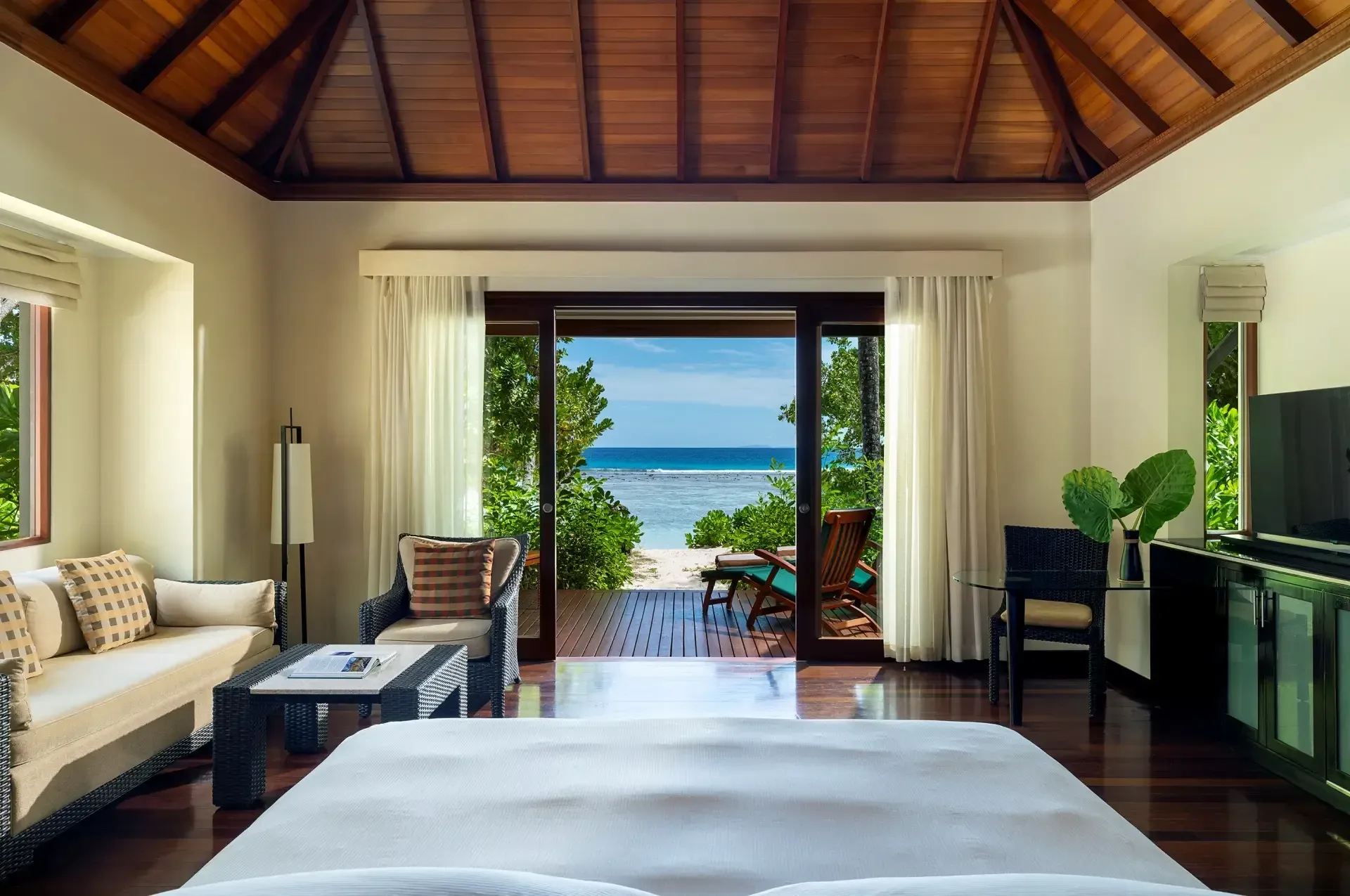 Beach Villa with Garden Plunge Pool bedroom opening to the beach at Niva Labriz Seychelles