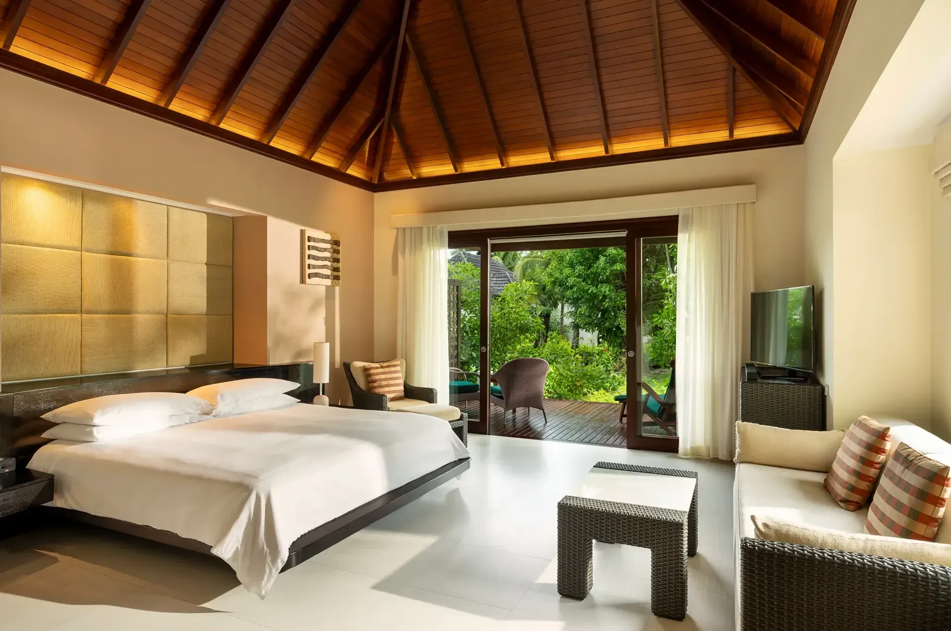 Garden Villa interior with king bed and terrace at Niva Labriz Seychelles