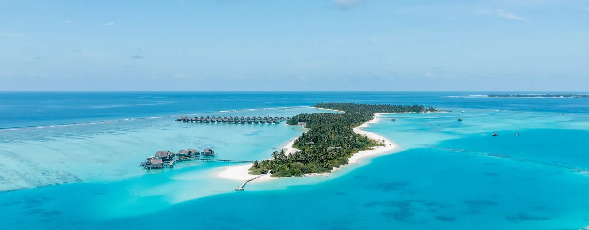 Aerial view of Niyama Private Islands Maldives with overwater villas and jungle-covered islands
